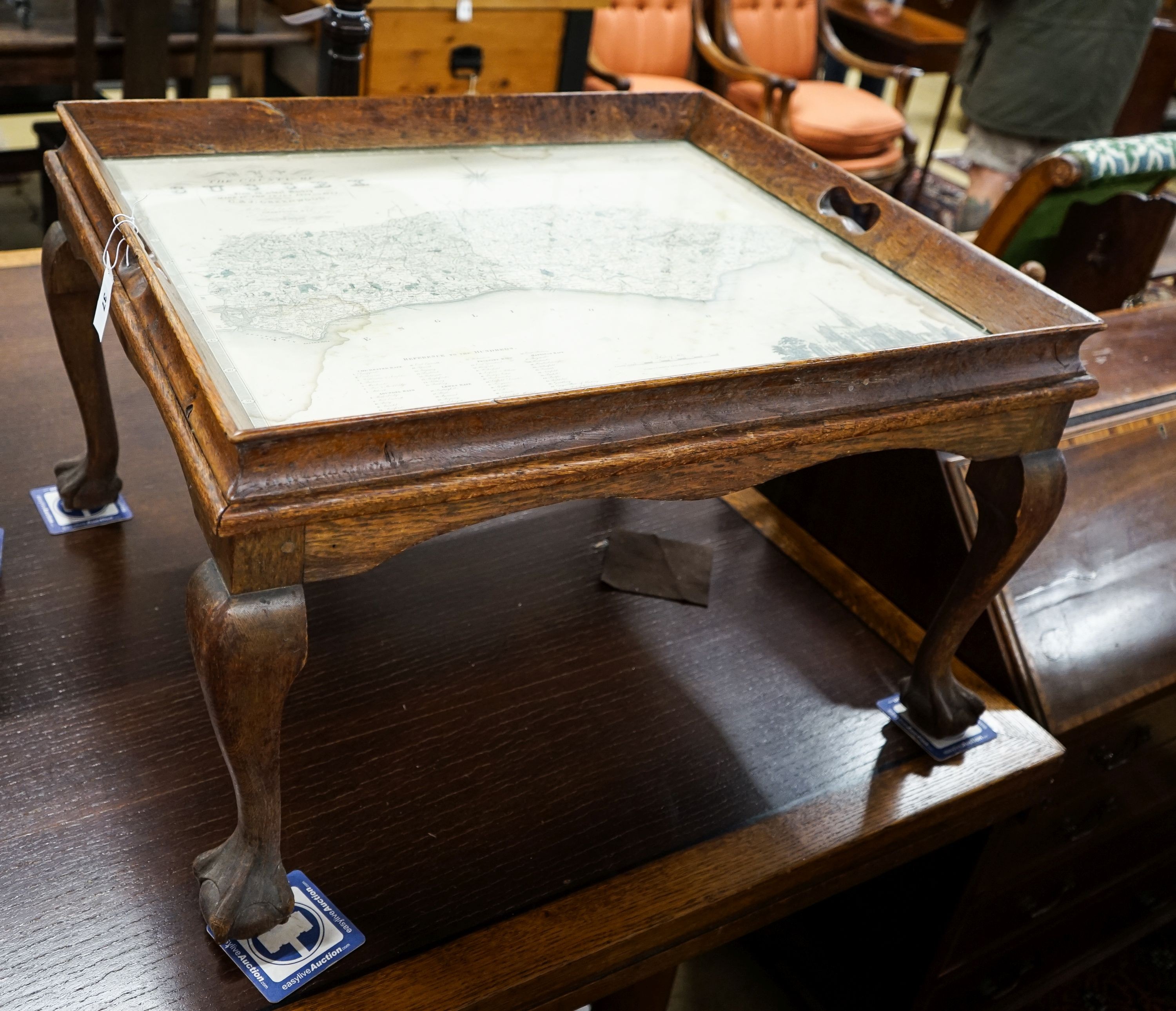 A rectangular oak tray top low table inset with a map of Sussex on ball and claw stand, width 81cm, depth 70cm, height 47cm